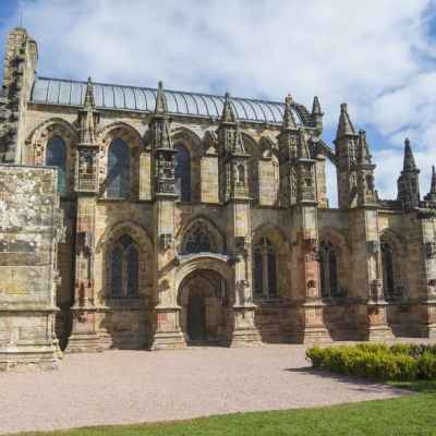 a large stone statue in front of a building