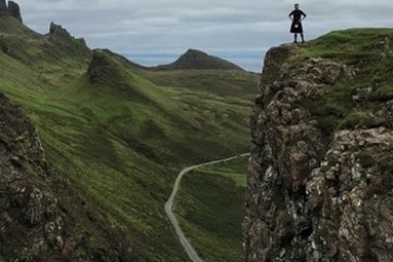 a person standing on a rocky hill