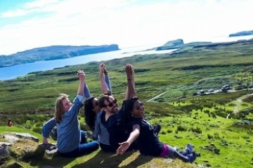 a group of people sitting on a grassy hill