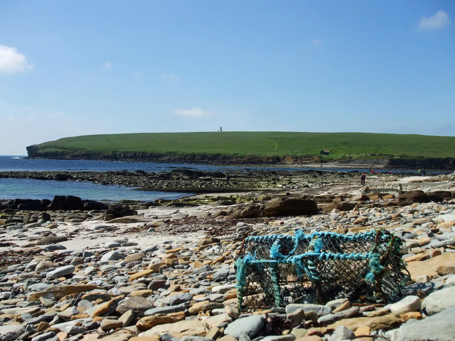 a person sitting on a rocky beach