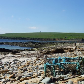 a person sitting on a rocky beach