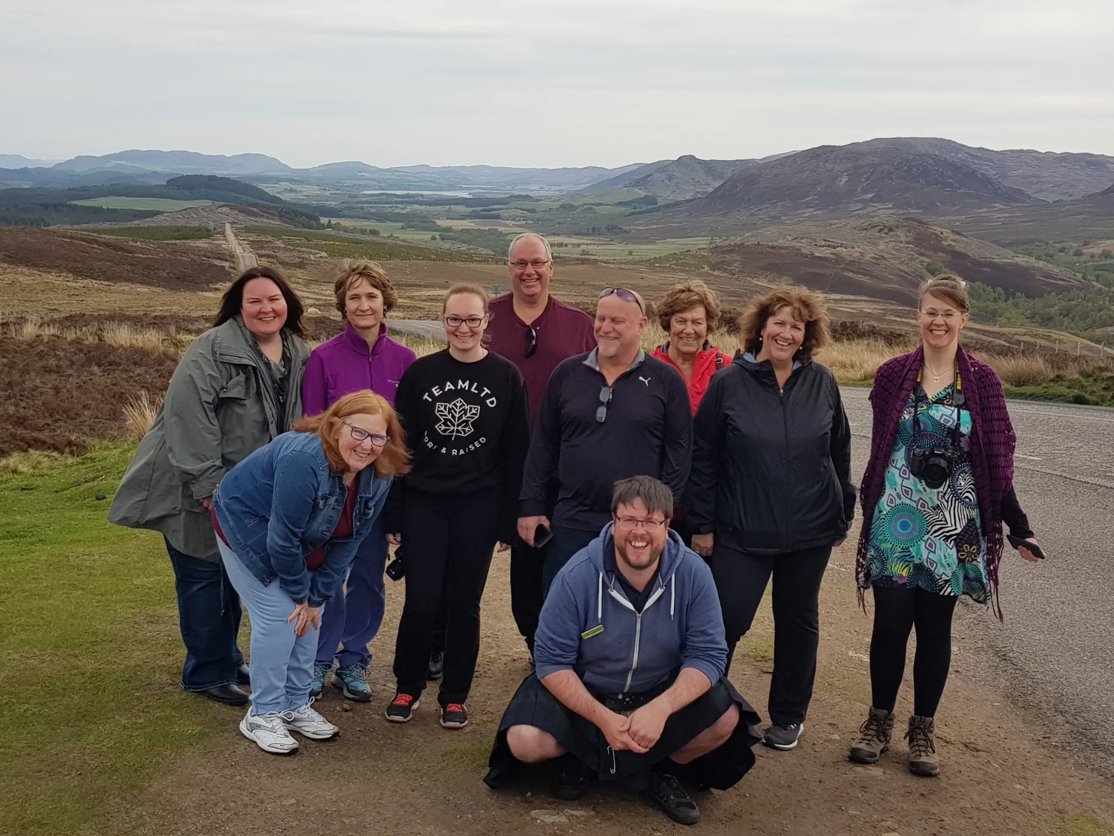 a group of people standing on top of a mountain