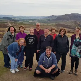 a group of people standing on top of a mountain