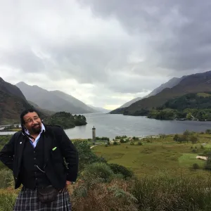 a man standing in front of a mountain