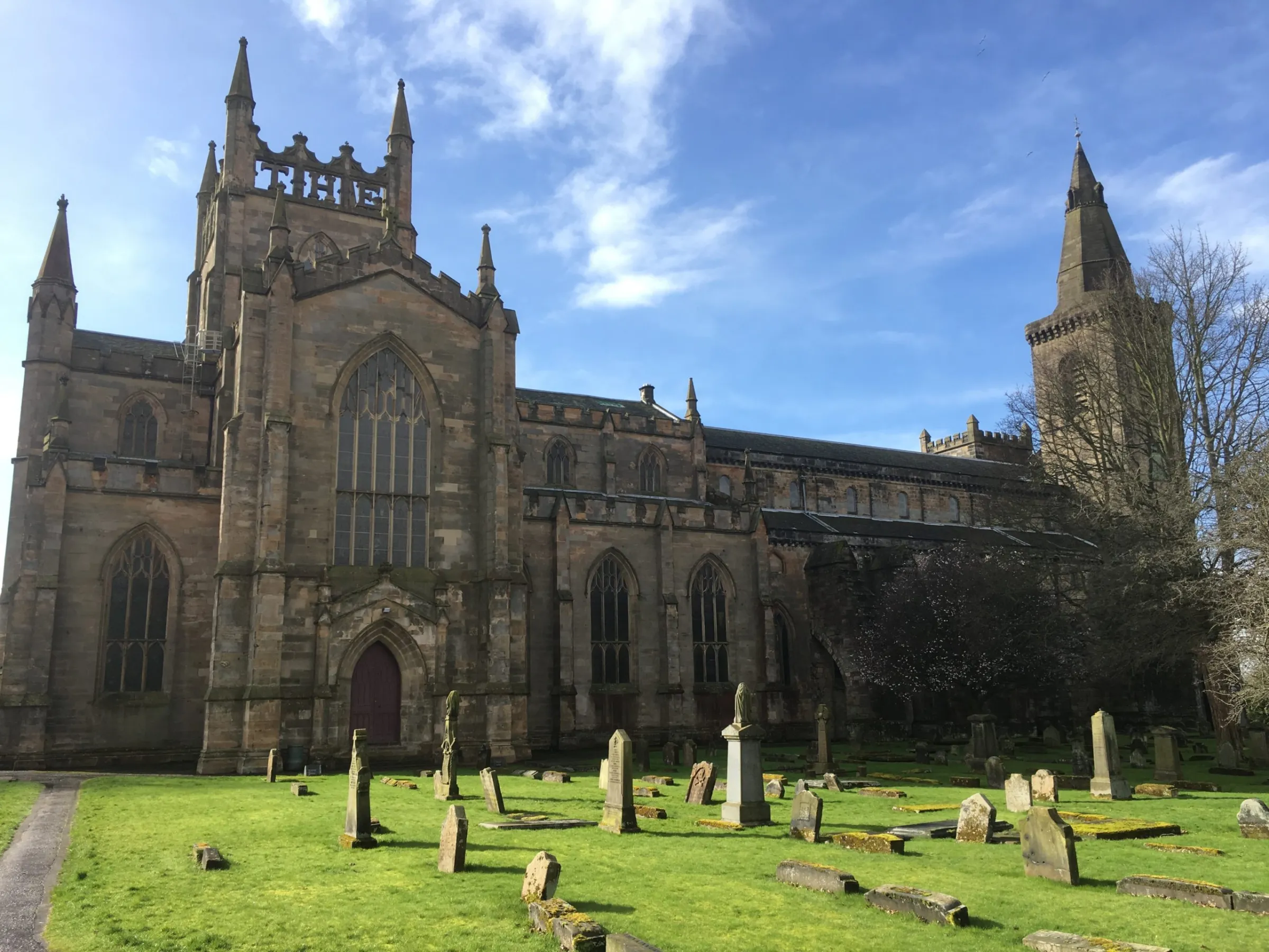 a large stone statue in front of a church