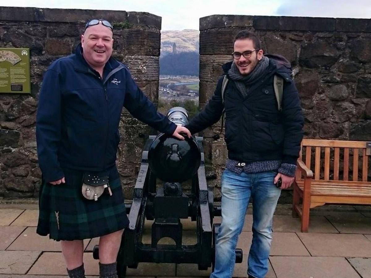 a group of people standing around a bench