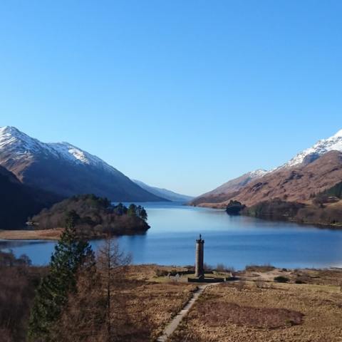 a body of water with a mountain in the background