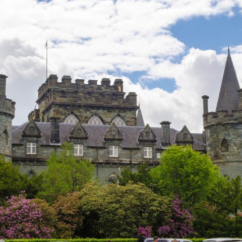 a castle with a clock tower in front of a building