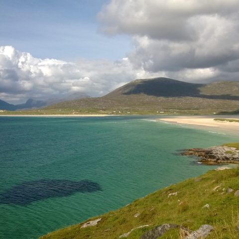 a body of water with a mountain in the background