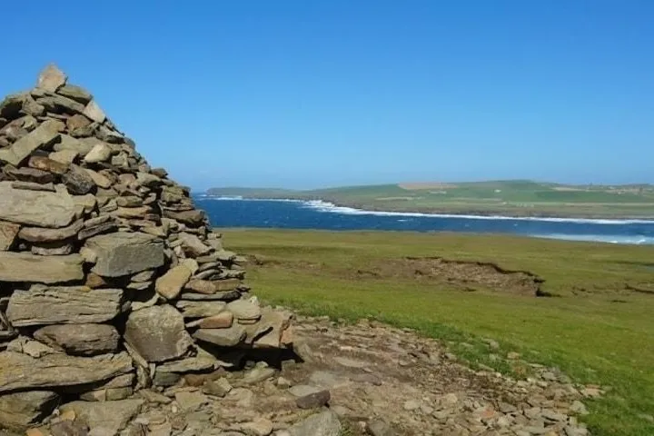 a close up of a rock near the ocean