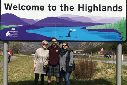 a group of people standing in front of a crowd posing for the camera