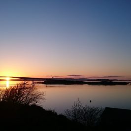 a sunset over a body of water