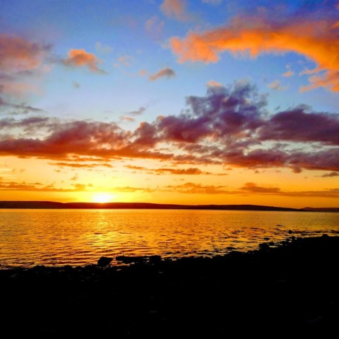 a sunset over a body of water