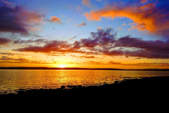 a sunset over a body of water