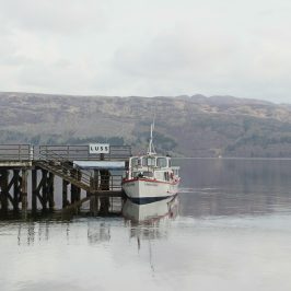 a boat is docked next to a body of water