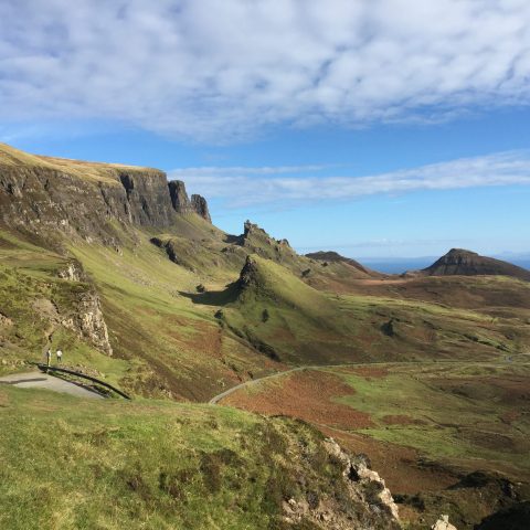 a rocky hill side with Quiraing in the background