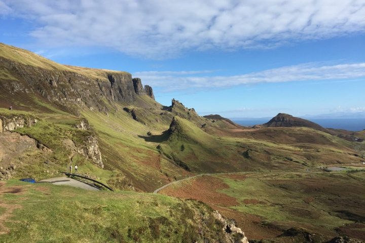 a rocky hill side with Quiraing in the background