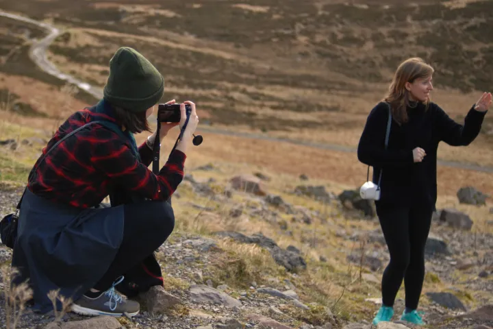 a couple of people that are standing in the sand