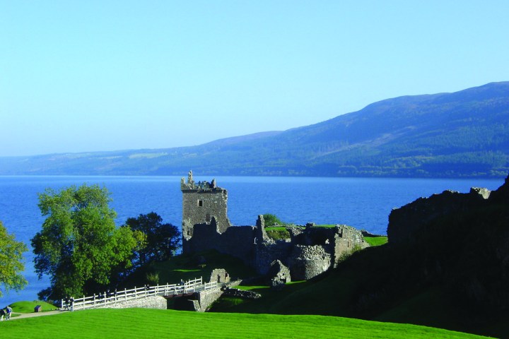 a large body of water with a mountain in the background