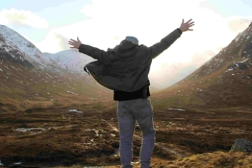 a man standing on top of a mountain