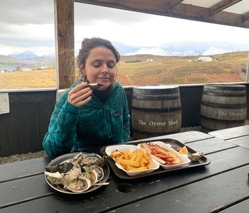a person sitting at a table eating food