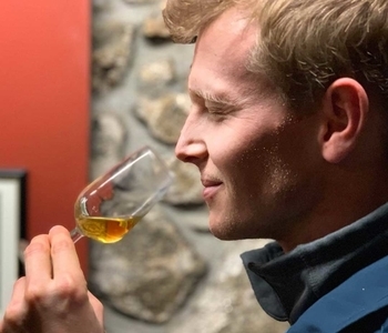 a man drinking from a wine glass