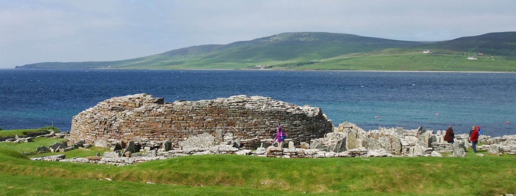 a group of people sitting in front of a body of water