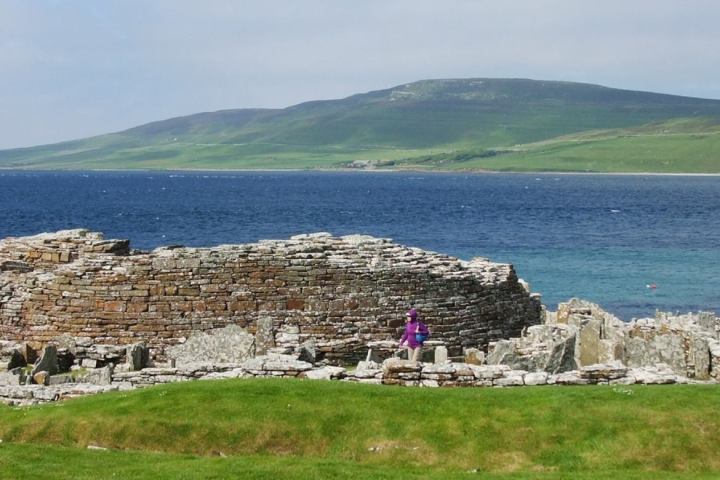 a group of people sitting in front of a body of water