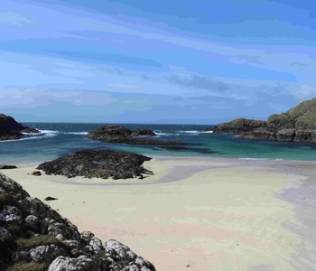 a rocky beach next to a body of water