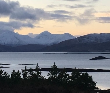 skye (2) a body of water with a mountain in the background