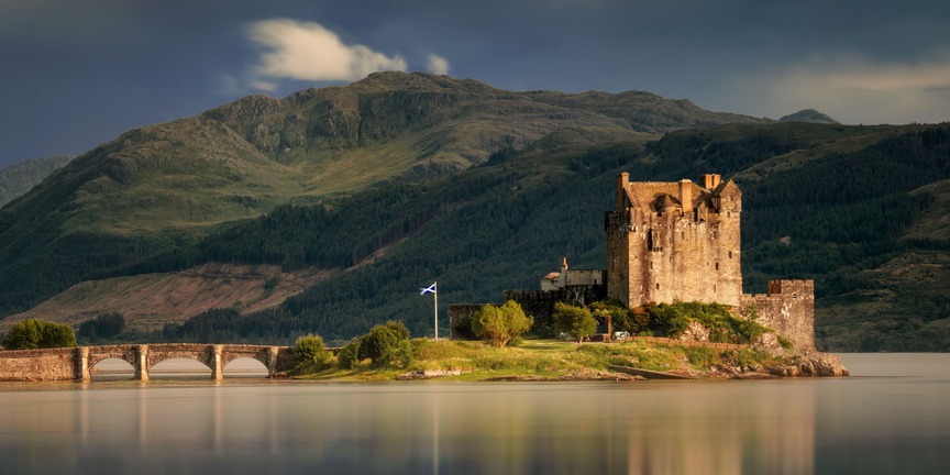 a castle with a mountain in the background