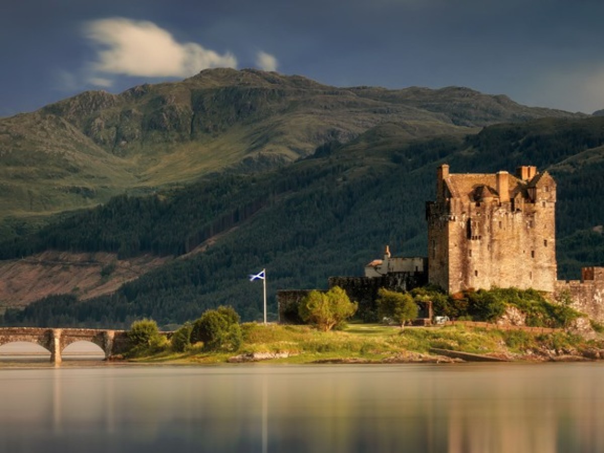 a castle with a mountain in the background
