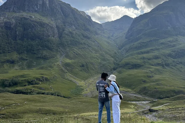 a man standing in front of a mountain