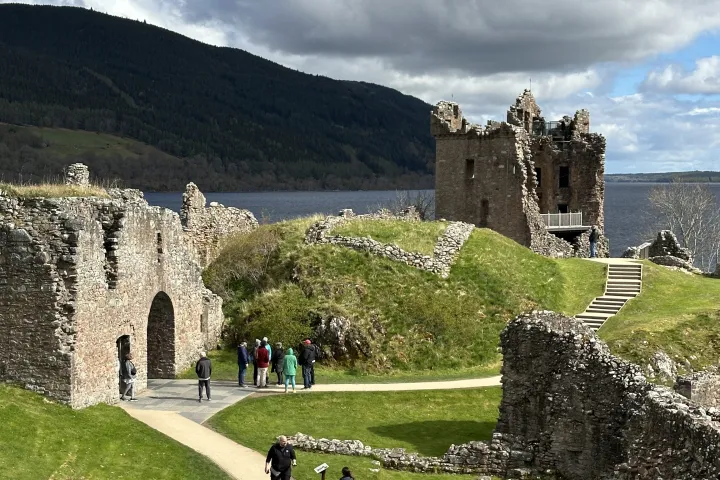 a group of people standing in front of a castle