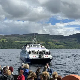 a group of people standing next to a body of water
