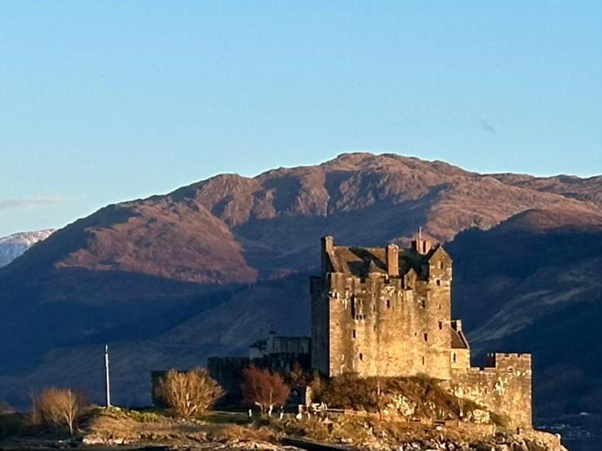 a body of water with a mountain in the background