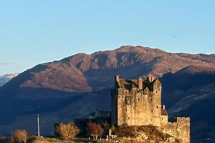 a body of water with a mountain in the background