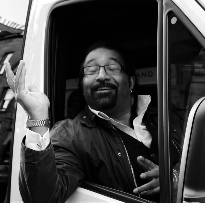 Rob-driver-1-scaled2 a man standing in front of a bus