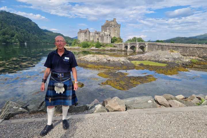a man standing on a rocky beach