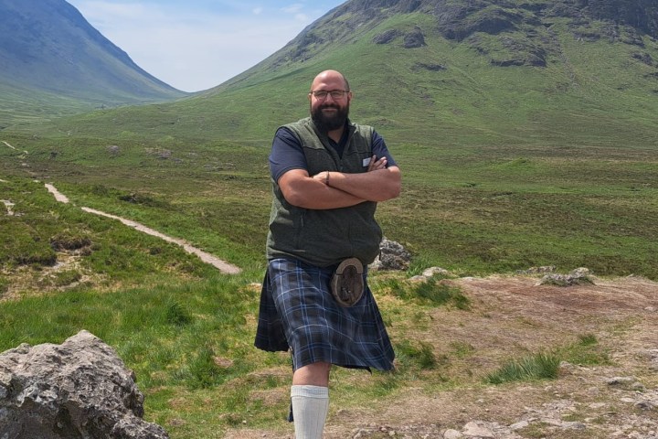 a man standing in front of a mountain