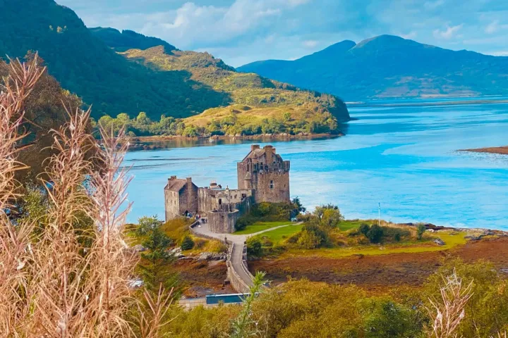 a body of water with a mountain in the background