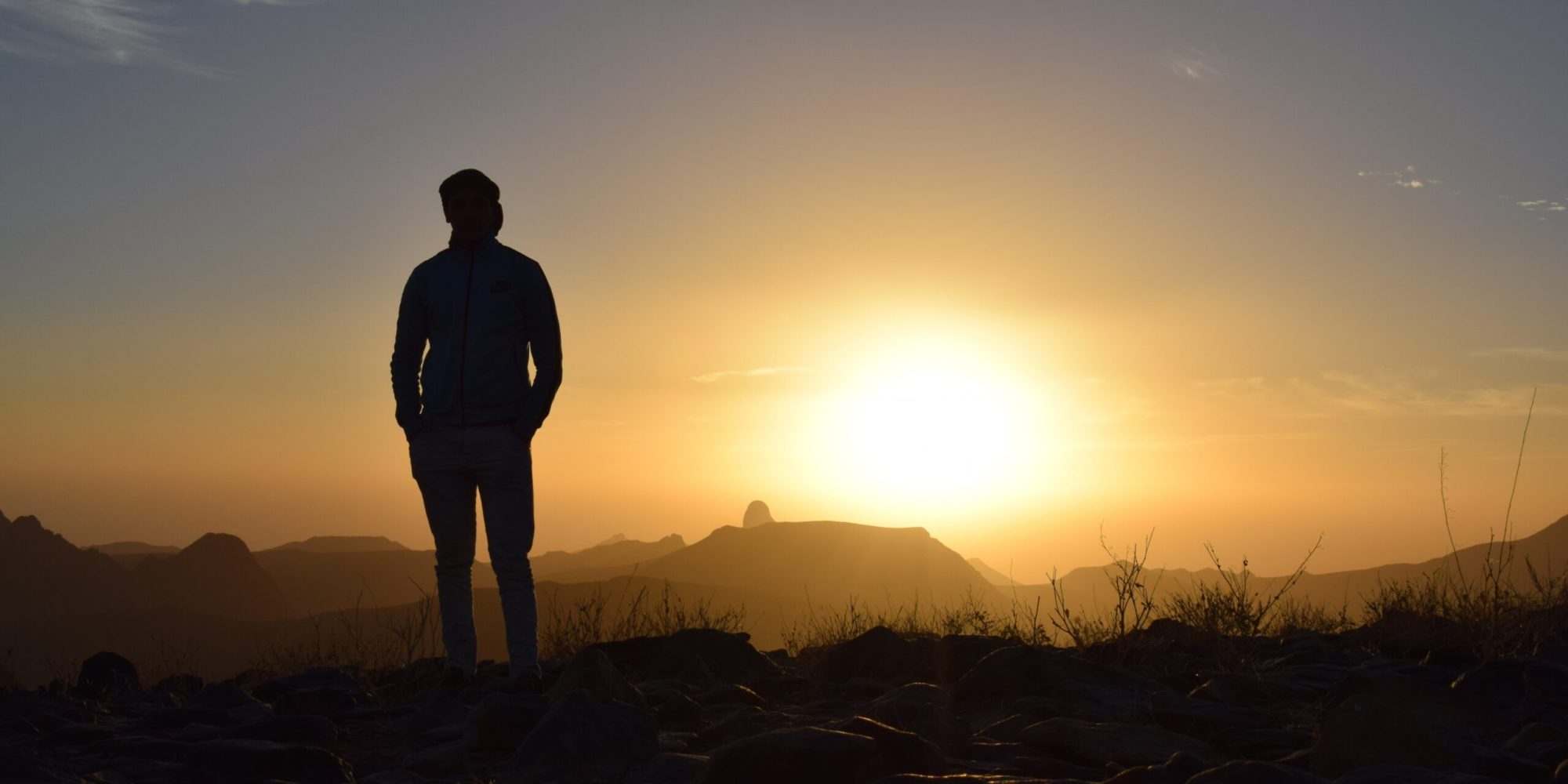 NewsletterLandspace a man standing in front of a sunset