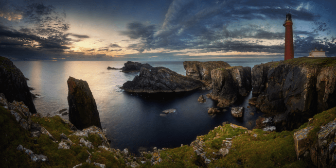 a rocky island in the middle of a body of water