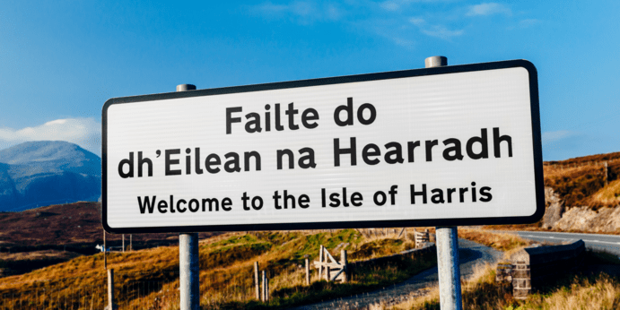 a sign with a mountain in the background