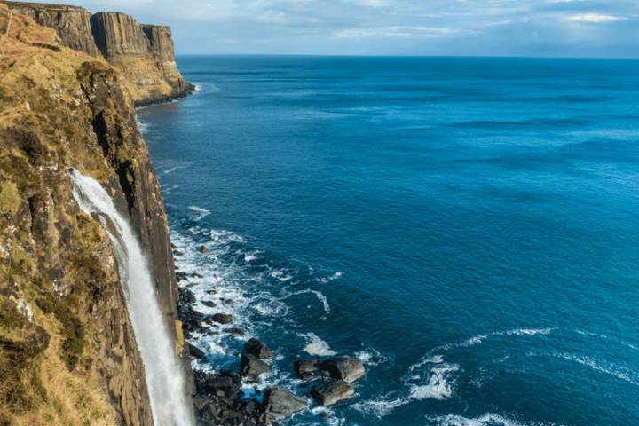 a rocky island in the middle of a body of water