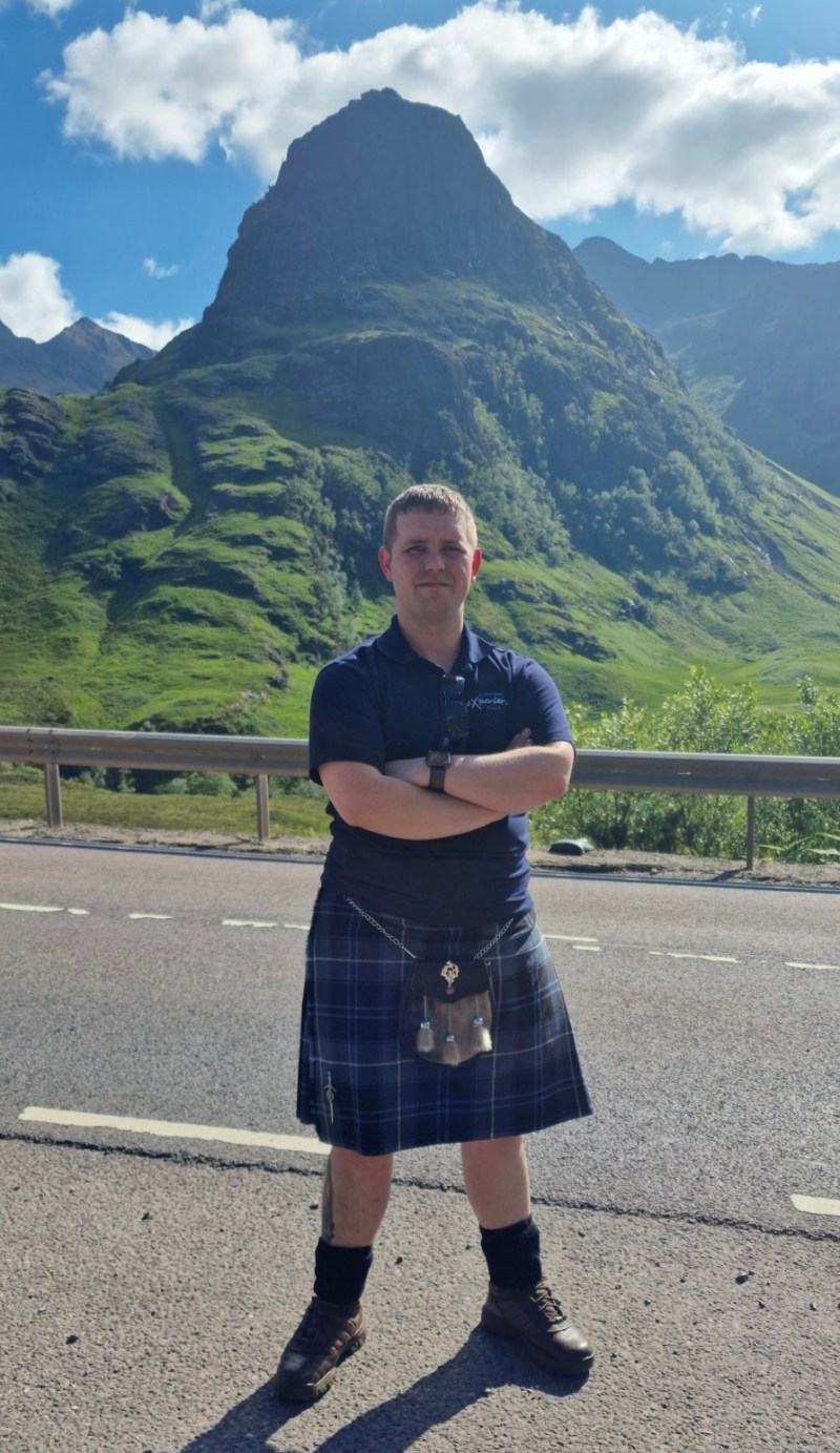 Graham a person standing in front of a mountain