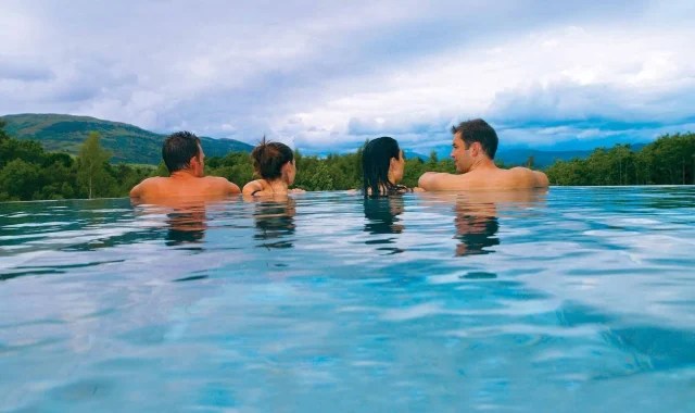 Spa-couples-infinity-pool-640×380 a group of people swimming in a body of water