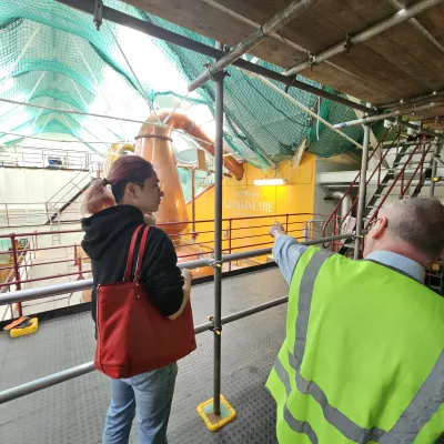 a couple of people that are standing in the rain