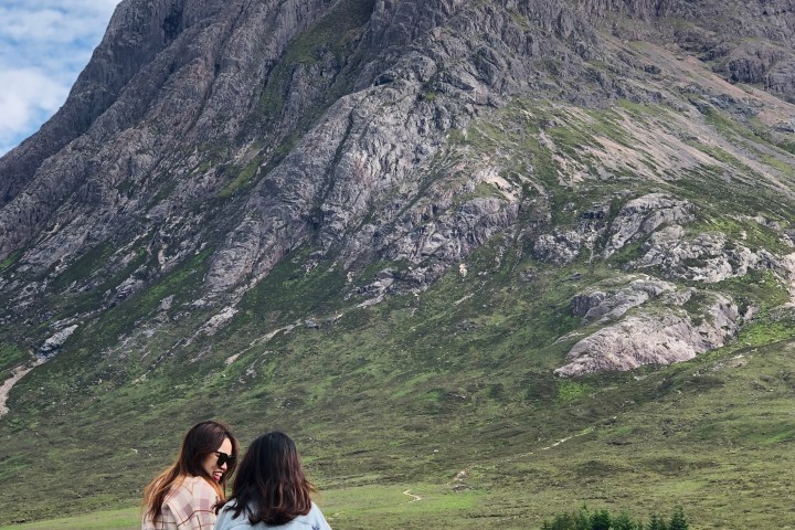 a group of people sitting on the side of a mountain