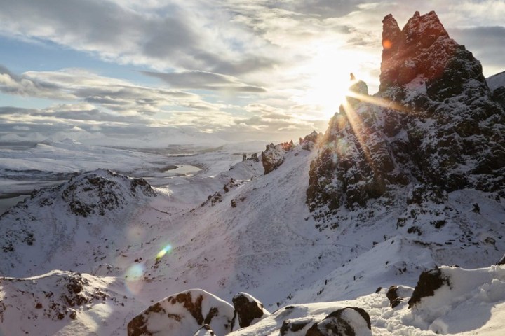 a man standing on top of a snow covered mountain